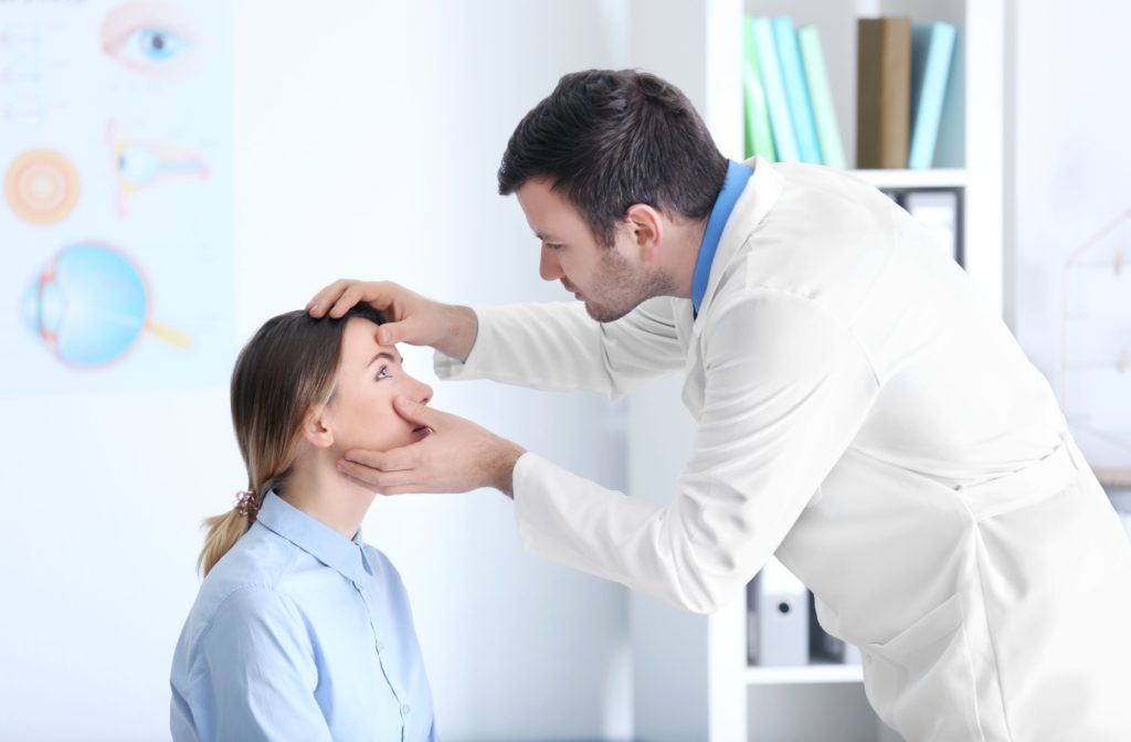 An ophthalmologist examining the eye of a patient.