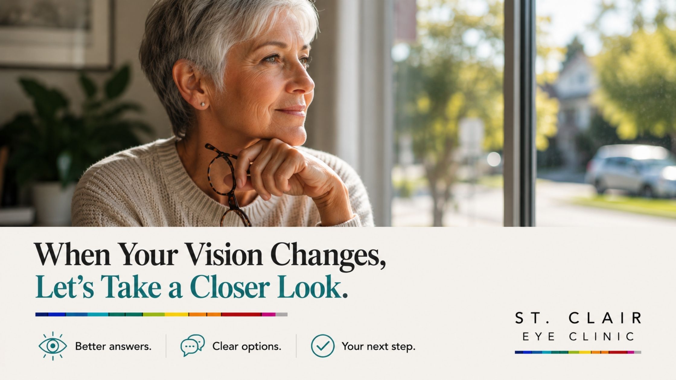 Older woman holding her glasses and looking outside, encouraging an eye exam when changes in vision become noticeable